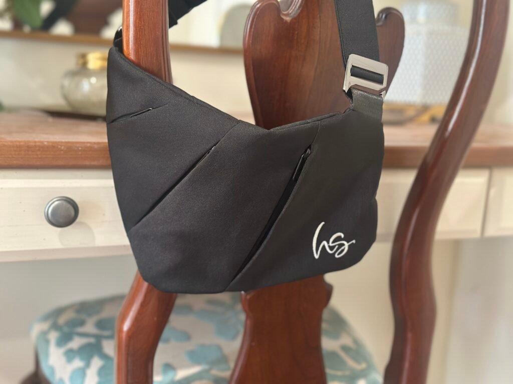 Black HipStyle Hip Bag hanging on a chair